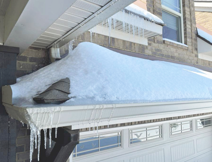 ice dams after a snow and freeze thaw cycle - winter storm damage